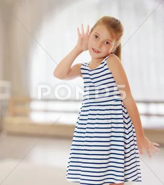 Little girl listens to Stock Photos