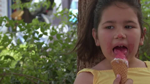 Little Girl Looking at Camera While Eating Ice Cream 7 스톡 동영상 196821726
