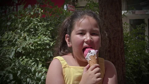 Little Girl Looking at Camera While Eating Ice Cream 3 스톡 동영상 196825622