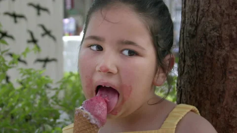 Little Girl Looking at Camera While Eating Ice Cream 9 스톡 동영상 196848682