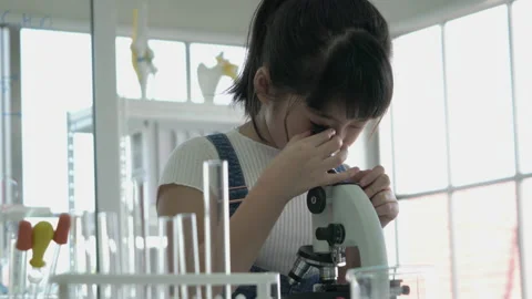 Little girl is looking microscope. Stock Footage 173595775