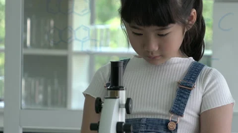 Little girl is looking microscope. Stock Footage 177952337