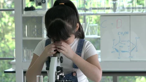 Little girl is looking microscope. Stock Footage 177953628