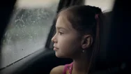 Little Girl Looking Out From Car Window. Rainy Weather Stock Footage