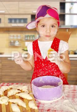 Little girl make sweet rolls .jpg Stock Photos