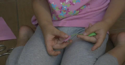 A Little Girl Makes a Paper Application Stock Footage 52365553