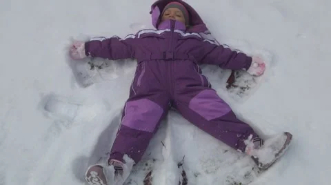 Little Girl Making Snow Angel, Child Playing in Snow, Children, Winter Games Stock Footage