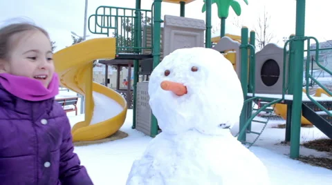 Little girl making a snowman Video stock 59979853