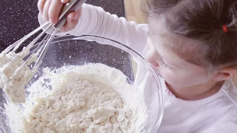Little girl mixing dough for home made p... | Stock Video | Pond5