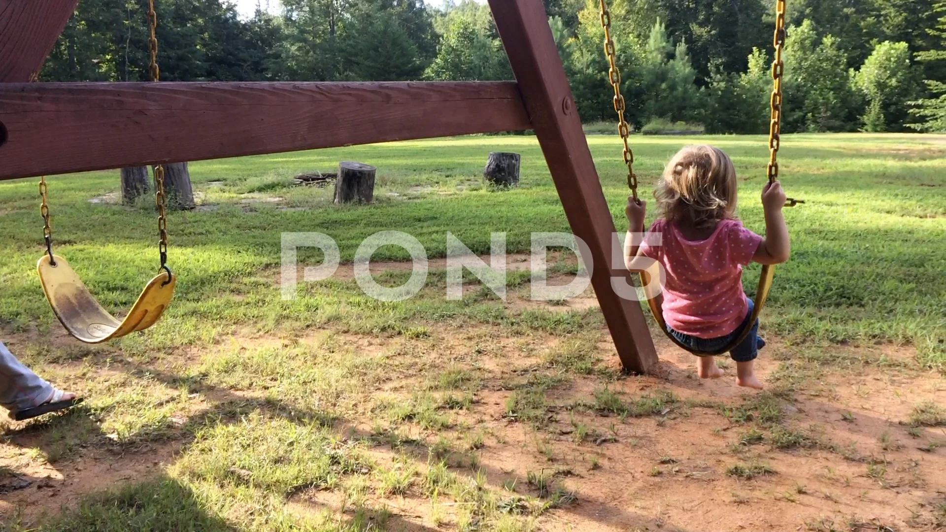 Little Girl With Mother Swinging In Backyard Hi Res 94079276