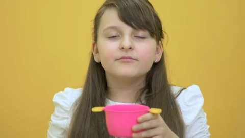 Little girl open pot, smell flavor and demonstrate plastic toy in close-up Stock Footage