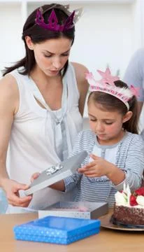 Little girl opening birthday gifts Stock Photos