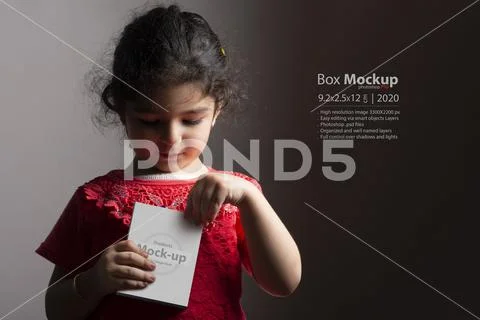 Little girl opening a small box in front of body mock-up series PSD Template