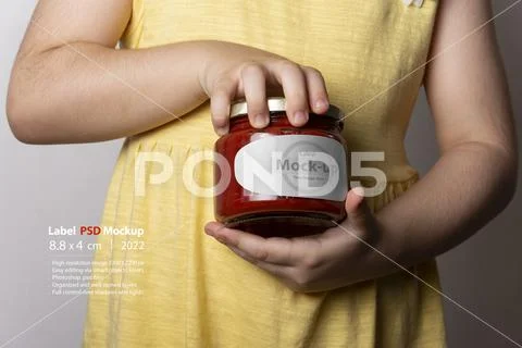 Little girl opening a tomato paste jar cap by hands mock-up series PSD Template