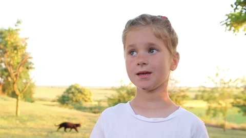 Little Girl Outdoor Talking To The Camera Stock Footage