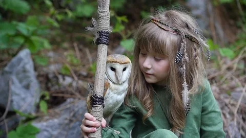 Little girl with an owl in a fairy forest. Friends Stock Footage