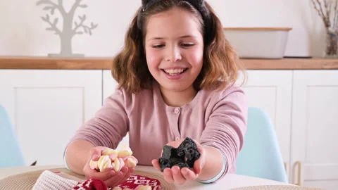 A little girl paints eggs for Easter. Child schoolboy of European appearance and Stockbeeldmateriaal 170455401