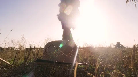 Little Girl picking up her Straw Hat from the ground Stock Footage