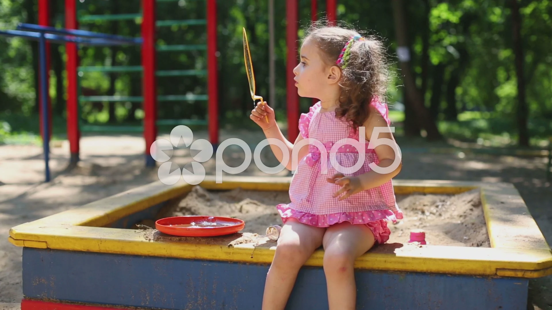 Little girl in a pink dress is blowing h, Stock Video