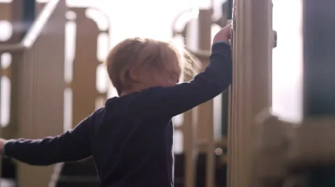 A little girl on a play structure getting scared, lens flare, slow motion Stock Footage 67167672
