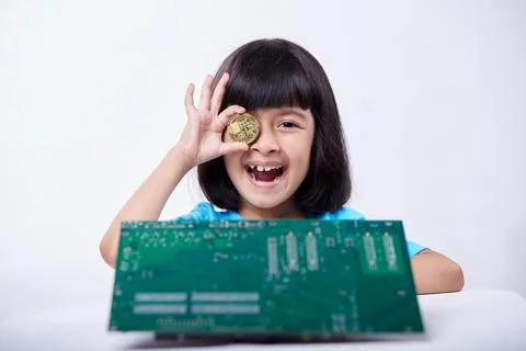 Little girl playing and learning with Cryptocurrency coins Stock Photos