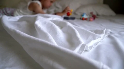 Little girl playing on the bed Stock Footage