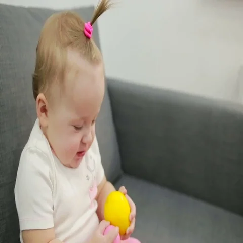 Little girl playing on the couch at the living room Stock Footage