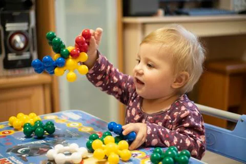 Little girl playing in the developing constructor Stock Photos