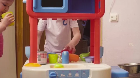 Little girl playing with dishes and food Stock Footage