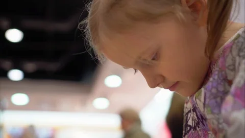 Little girl is playing a game using a smartphone. Face close-up Stock Footage 82131089