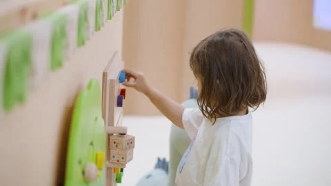 Little girl playing with interactive wall games, exploring and learning, Stock Footage 292738643