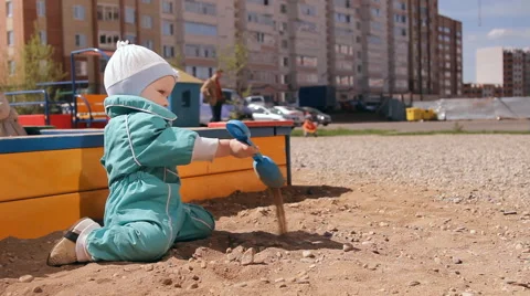 Little girl playing in the sandbox Stock Footage 59100239