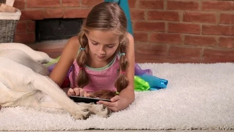 Little girl playing on tablet computer Video stock 69765613