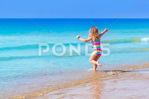 Little Girl Playing On Tropical Beach
