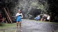 Little Girl Playing Under The Rain Stock Footage