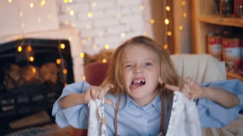 Little girl plays the fool, she is making fun with closing her face. Stock Footage 120398198