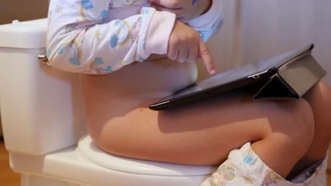 Little girl poops on toilet-shaped potty... | Stock Video 