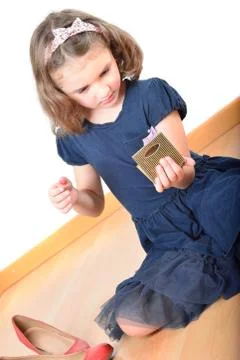 Little girl posing while making up Stock Photos