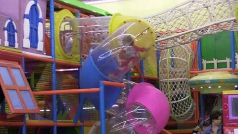 Little girl pulls down a pipe in a playground Video stock 133004355
