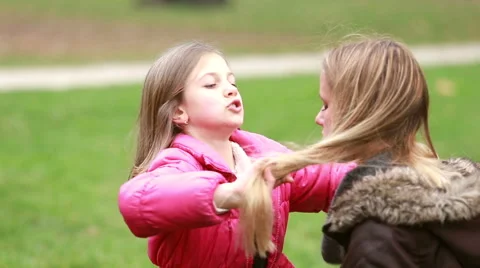 Little girl putting her hands through her mother's hair Stock Footage 59554630