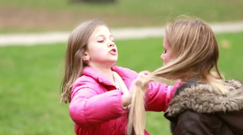 Little girl putting her hands through her mother's hair Stock Footage 59554631