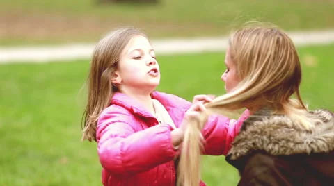 Little girl putting her hands through her mother's hair Stock Footage 59554633