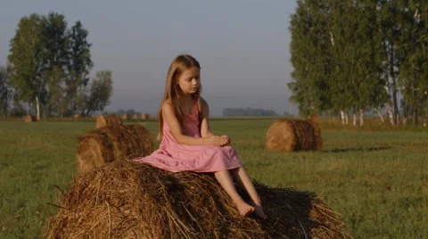 Little girl relaxing on a haystack Stock Footage 44448921