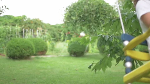 Little girl riding on a swing in the park Stock Footage
