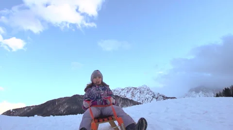 Little Girl Roars With Excitement While Sledging Down Snowy Hill Stock Footage 45307857