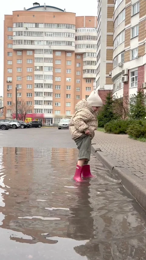 little girl in rubber boots playing in Stock Video Pond5