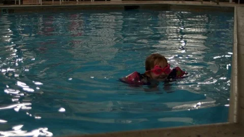 Little Girl Simming With Floaties On Video stock 86226156