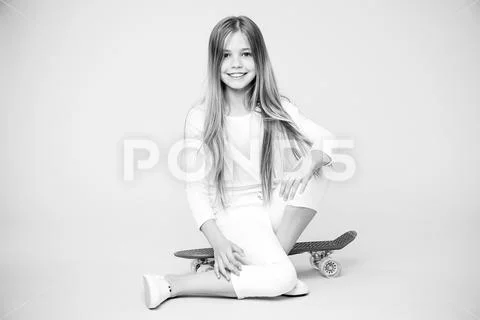 Little girl sit on penny board. Happy little girl enjoy happy childhood Stock Photos