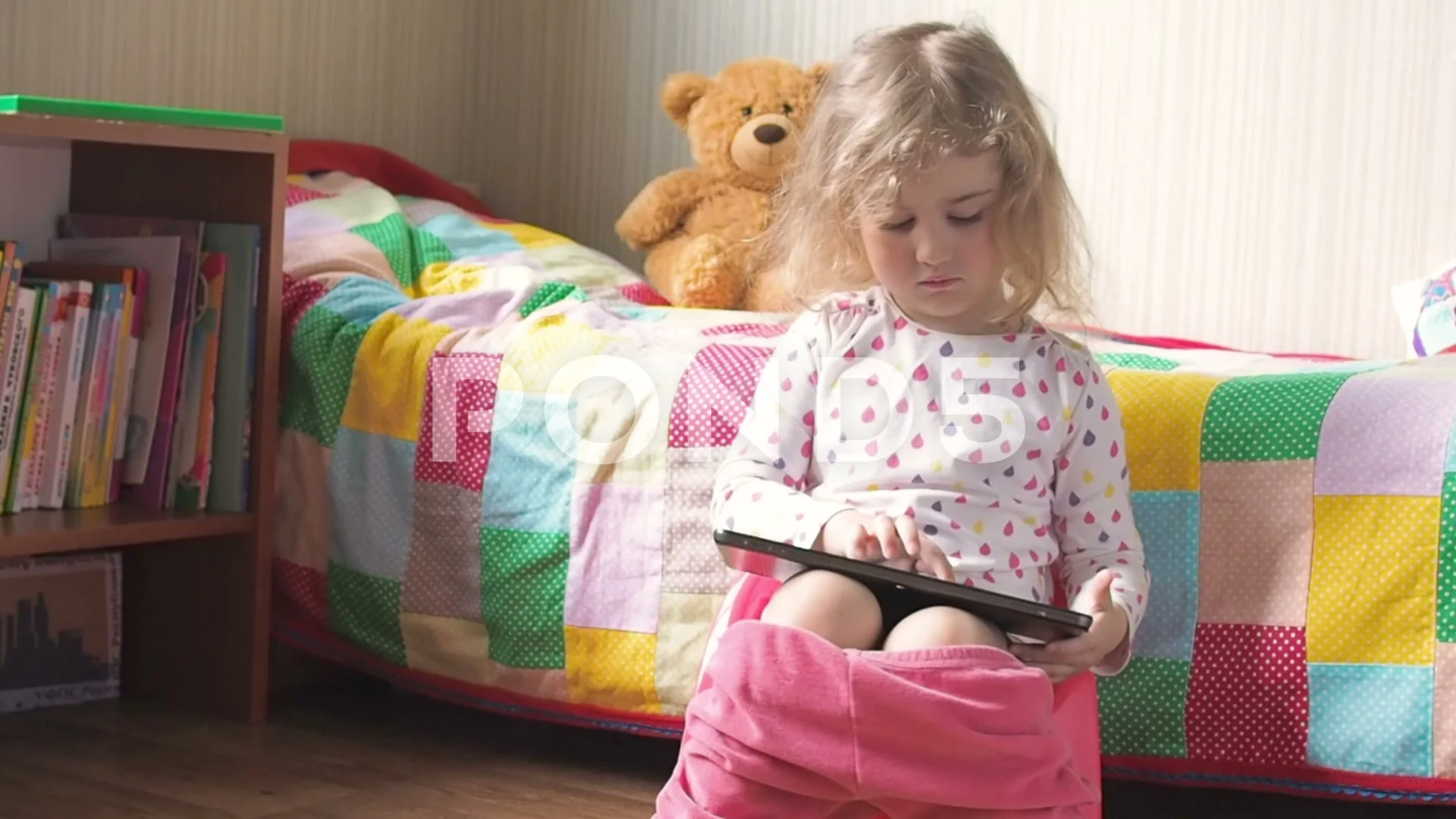 Toddler Girl On A Potty In The Living Room High-Res Stock Photo