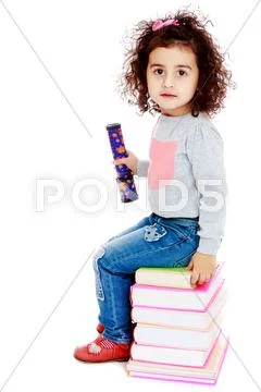 Little girl sitting on stack of books Stock Photos